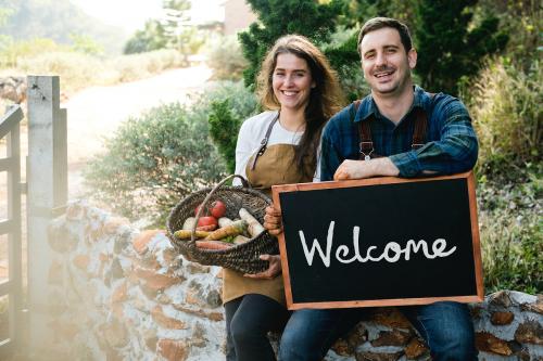 Farmers holding a blackboard welcoming sign - 484632