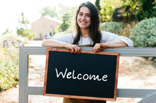 Farmer holding a blackboard welcoming sign - 484668