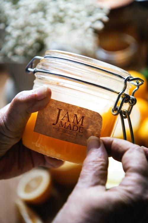 Putting a label on a jar of jam - 484780