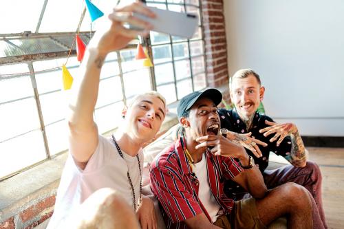 Diverse group of friends taking a selfie at a party - 2097298