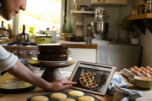 Woman reading baking recipe on a tablet - 485400