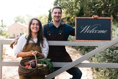 Farmers holding a blackboard welcoming sign - 485443