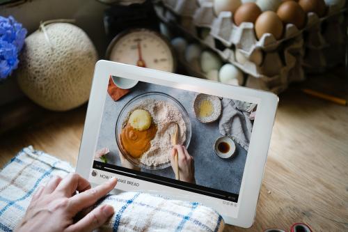 Woman watching how to make bread on a screen - 485463