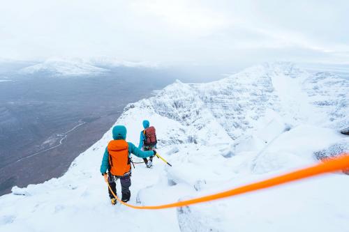 Mountaineers climbing a snowy Liathach Ridge in Scotland - 2221587