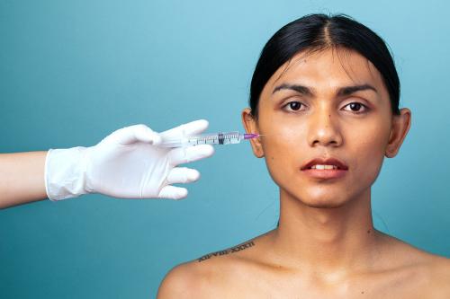 Beautiful woman gets a botox injection on her face - 2224847