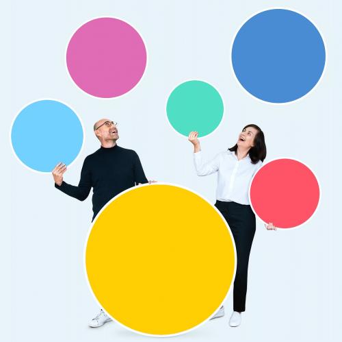 Happy people holding colorful round boards - 475546