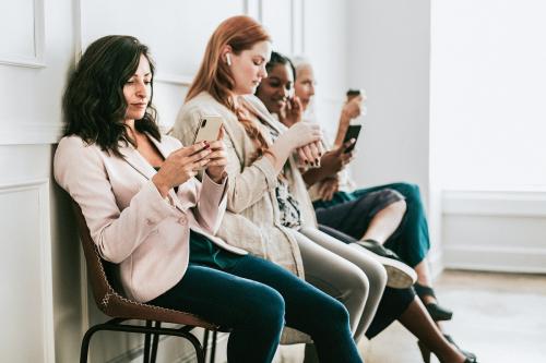 Businesswomen using digital devices while waiting - 1224199