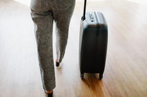 Woman and her luggage getting ready for a trip - 1226835