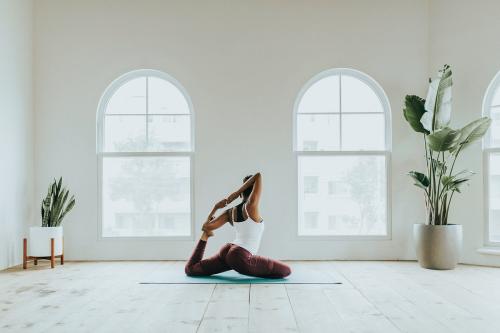 Black woman doing a Naginyasana pose - 1226949