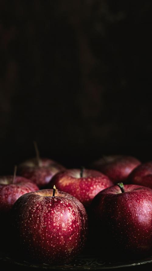 Fresh red apples on a plate - 1228610