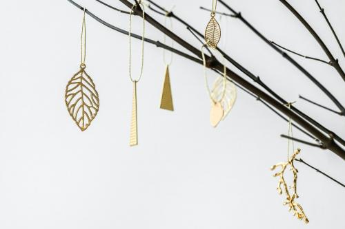 Festive golden Christmas ornaments on a branch - 1231310