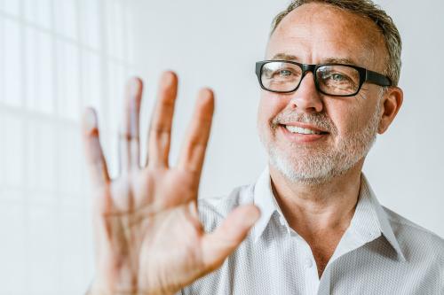 Man pressing his palm to a screen - 1233782