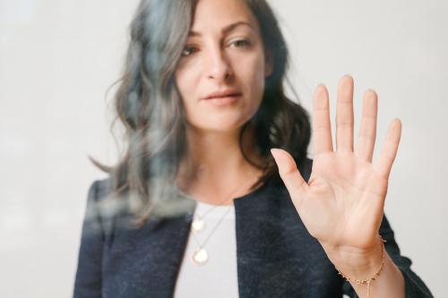 Woman touching a screen with her palm - 1233837