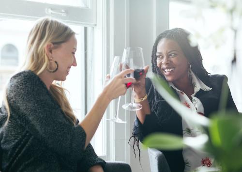 Colleagues toasting wine glasses at work - 1220761