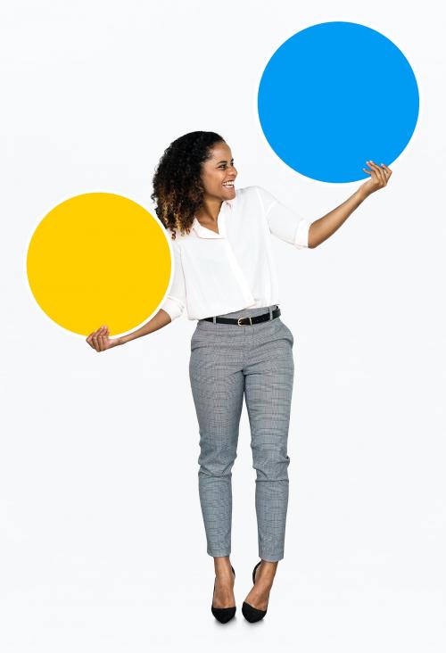 Cheerful woman holding colorful round boards - 475108