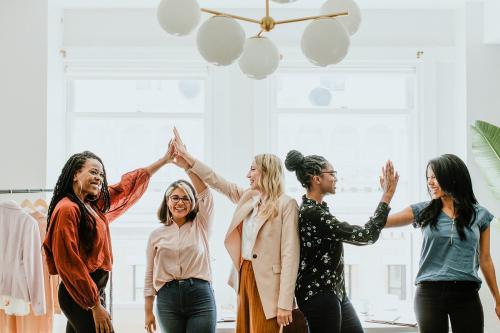 Businesswomen giving a high five to team - 1220914