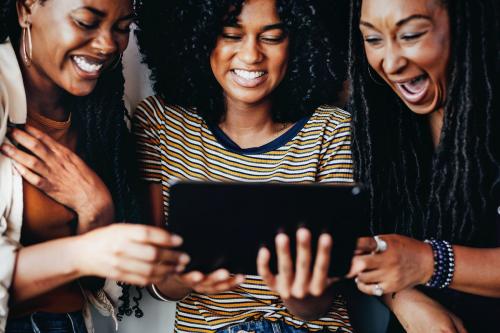 Girls watching an online video clip on a digital tablet - 1223773