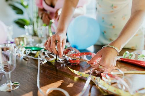 Host setting the table for a birthday party - 1225195