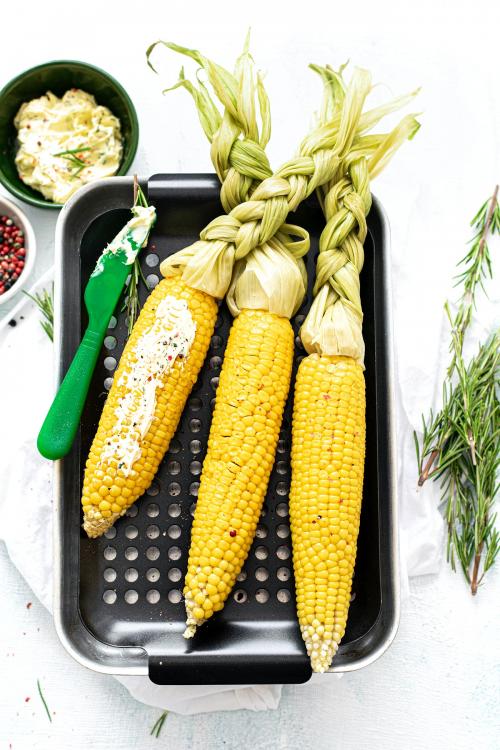 Fresh corn on the cob with organic rosemary leaves - 1225290
