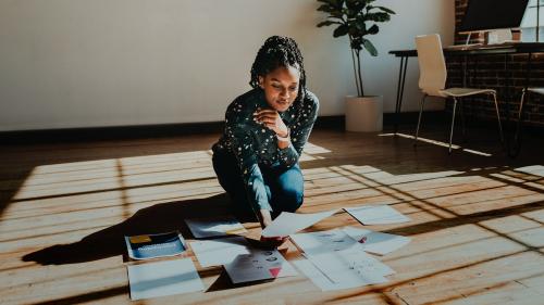 Businesswoman planning a marketing strategy on a wooden floor - 1226792