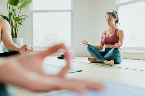 Healthy people doing a Sukhasana yoga pose in a yaga class - 1226973