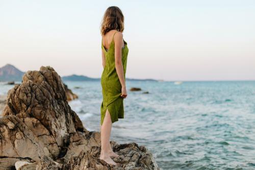 Woman at a rocky beach - 1228448