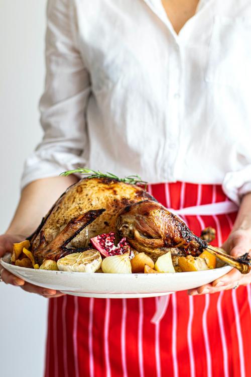 Woman preparing for roasted turkey for thanksgiving - 1228603