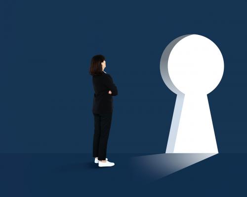 Woman standing in front of a huge keyhole - 475301