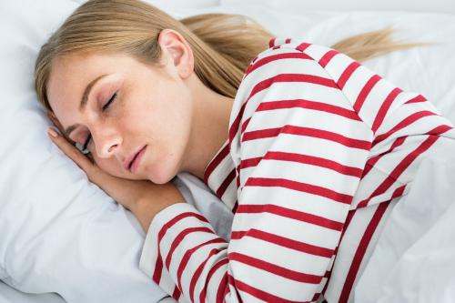 Blond girl sleeping on her bed - 1231754