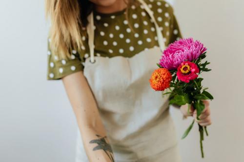 Blond woman making a bouquet of flowers - 1231956