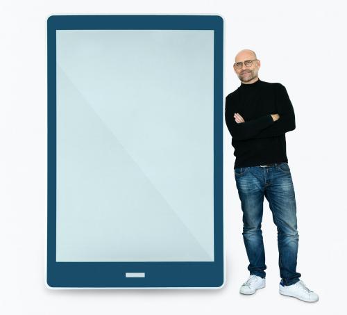 Happy man standing beside a tablet - 475420