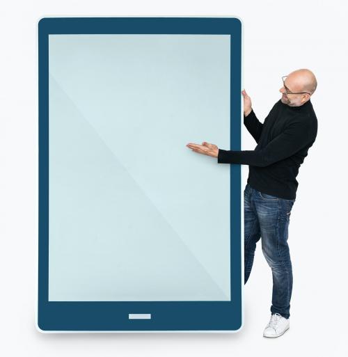 Cheerful man standing beside a tablet - 475426