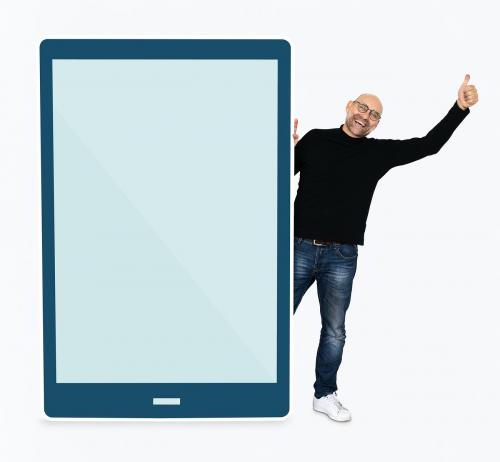 Cheerful man standing beside a tablet - 475432