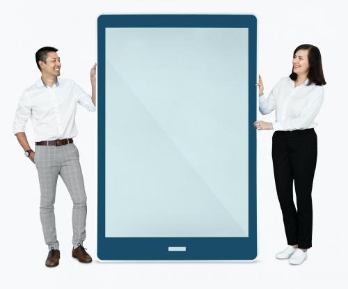 Cheerful people standing beside a tablet - 475476