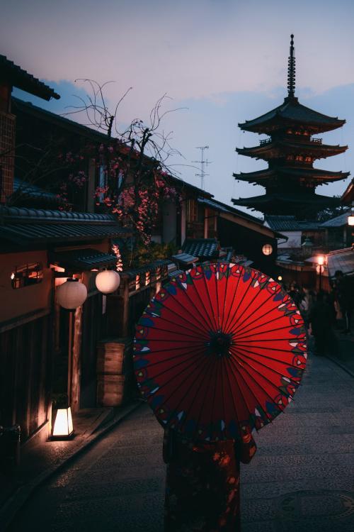 Woman in a kimono walking with a red umbrella at Yasaka Pagoda in Kyoto, Japan - 843881