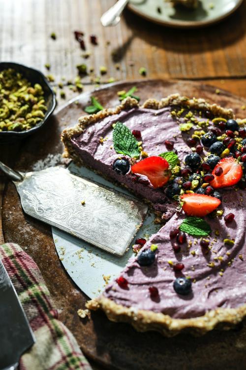 Sliced sweet potato tart topped with strawberries and blueberries - 844786