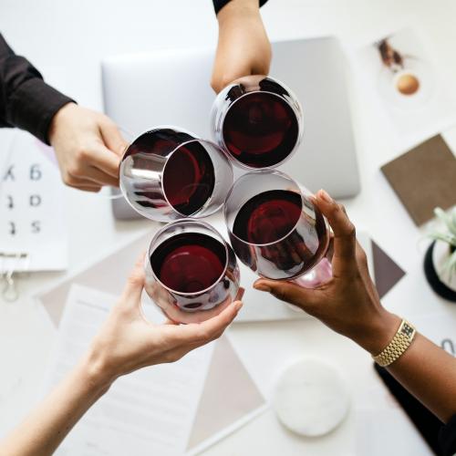 Colleagues toasting wine glasses at work - 1220933