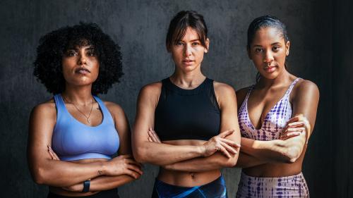 Sportive female personal coaches standing with arms crossed - 1222527