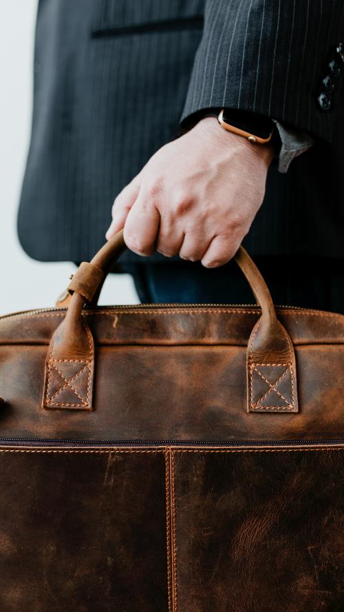 Businessman carrying his brown leather business bag - 1226667