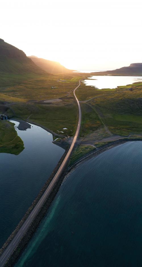 Road along the lake in the morning drone shot - 1227121