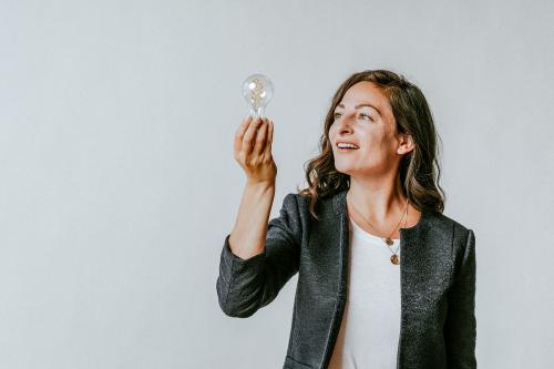 Woman holding a light bulb - 1233850