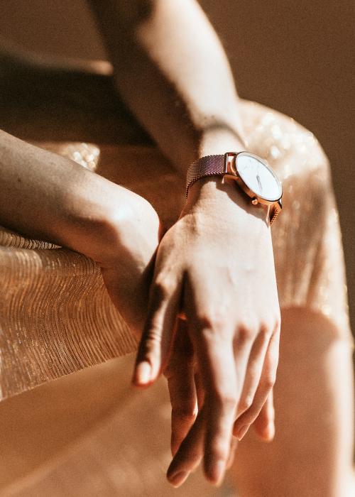 Woman wearing a pink gold wristwatch - 1235453