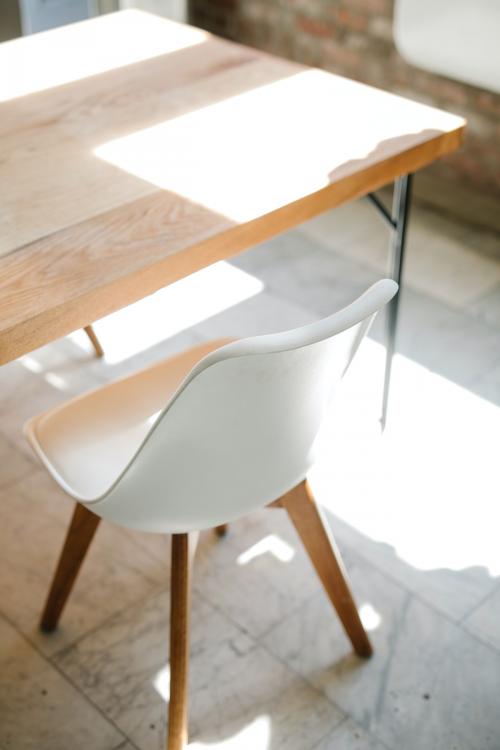 Wooden table and white chair on a marble floor - 2012673