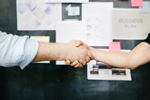 Happy c olleagues holding hands in the office - 2012747