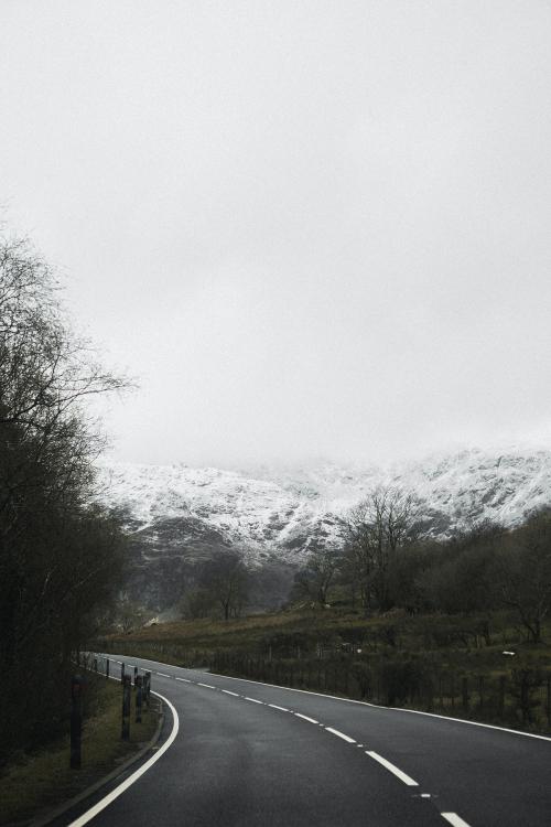 View of a road leading to snowy mountains - 598411