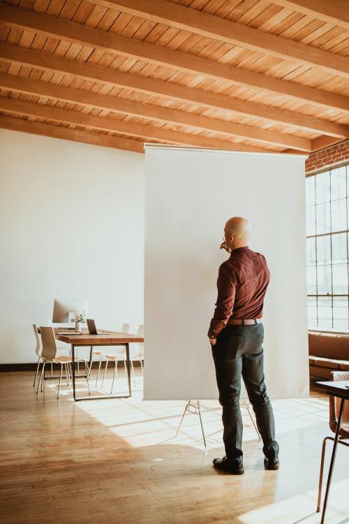 Businessman standing by a presentation board - 1218026