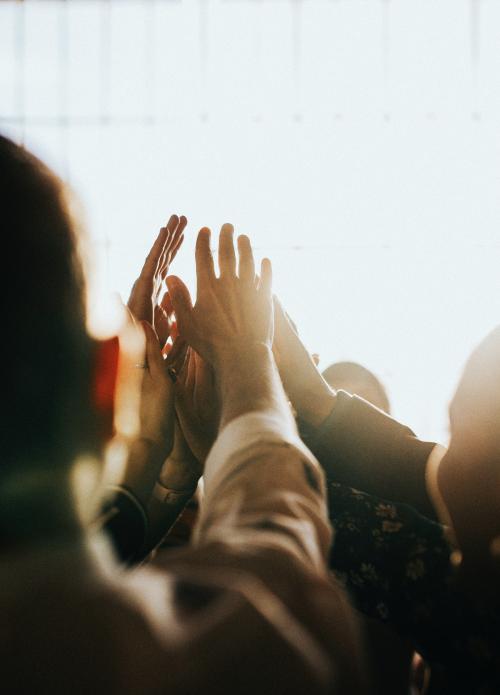 People joining hands in the air - 1218031