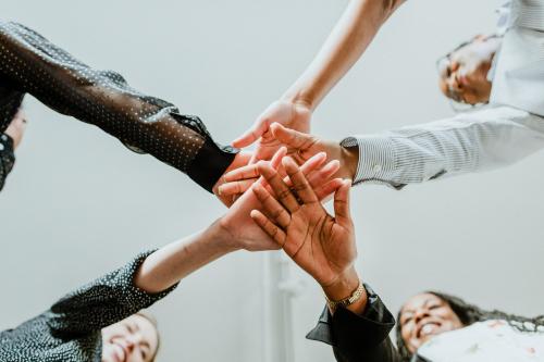 Empowering women stacking their hands - 1220753