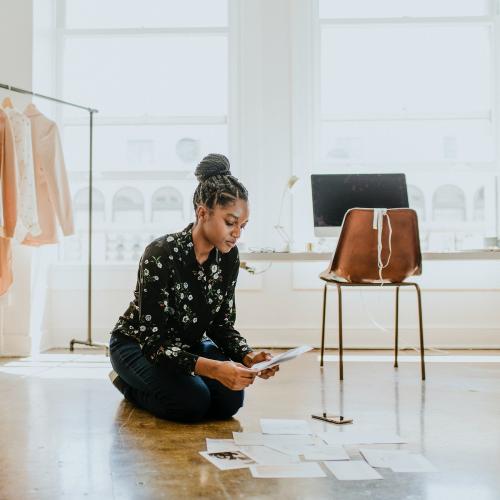 Young female designer in a boutique - 1220976