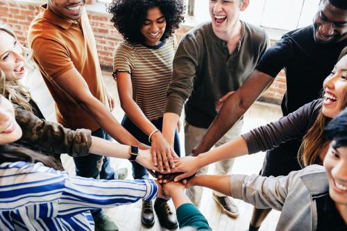 Group of diverse people stacking hands in the middle - 1223795